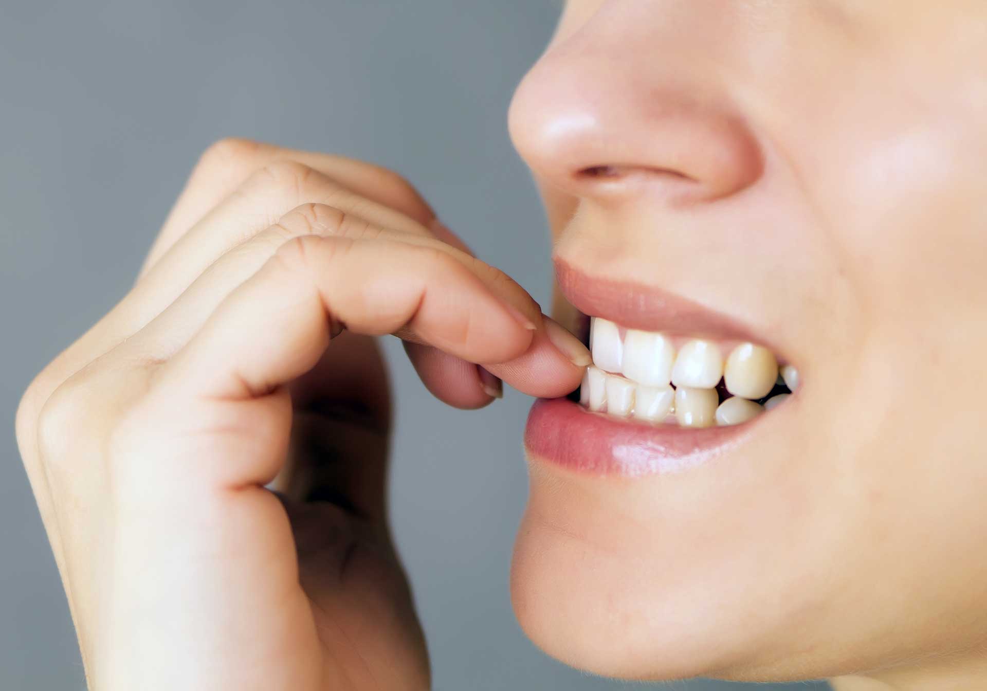 The Dental Dangers of Teeth Grinding and Nail Biting